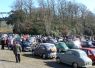 Morris and Austin cars gather on the old banked race track at Brooklands